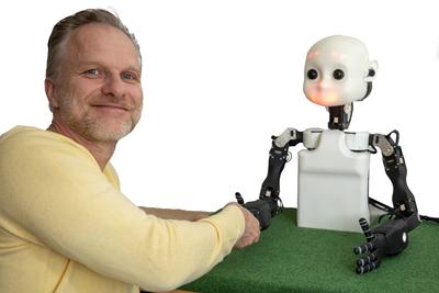Robot NICO and a human shaking hands